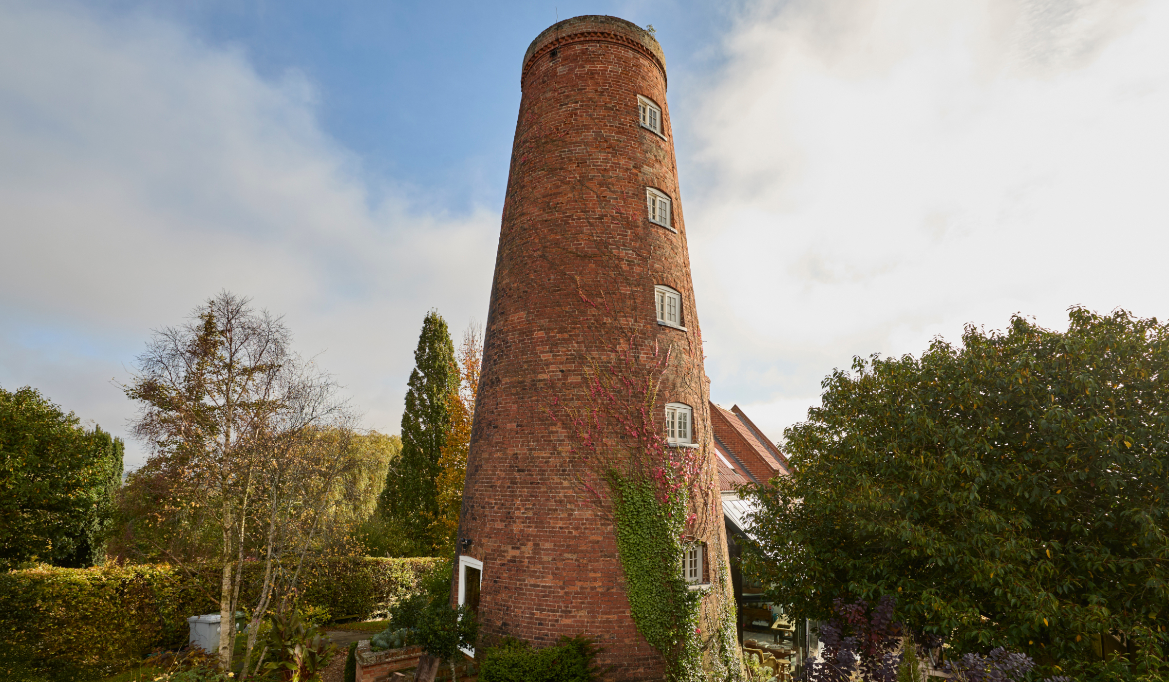 A nineteenth century windmill overlooks a curated garden