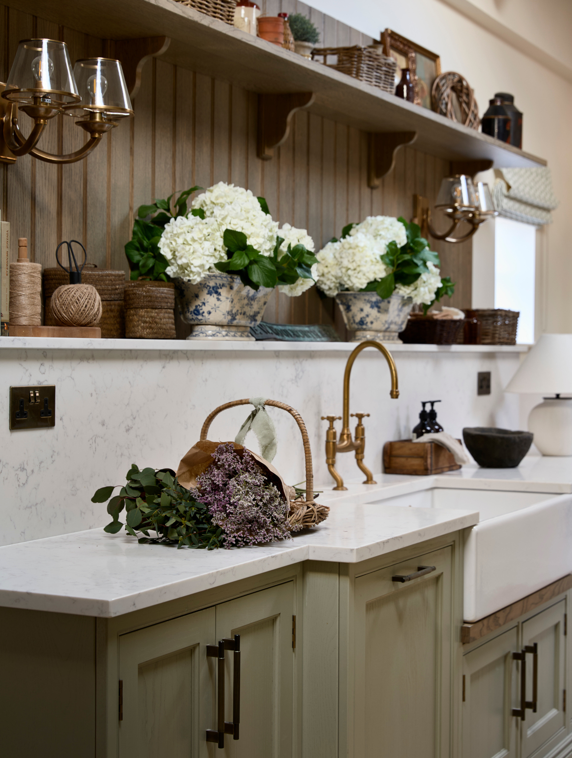 A traditional bootroom-cum-larder. The Belfast sink and worktop sits beneath two mounted cupboards. A antique brass Perin & Rowe Tap features. 