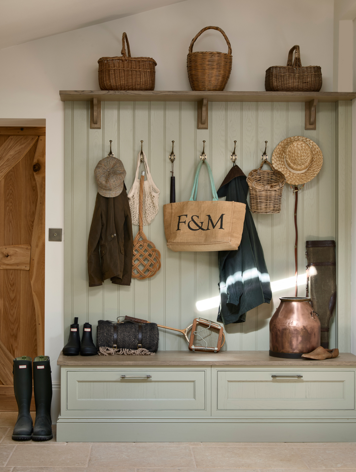 A traditional bootroom-cum-larder. The Belfast sink and worktop sits beneath two mounted cupboards. A antique brass Perin & Rowe Tap features. 