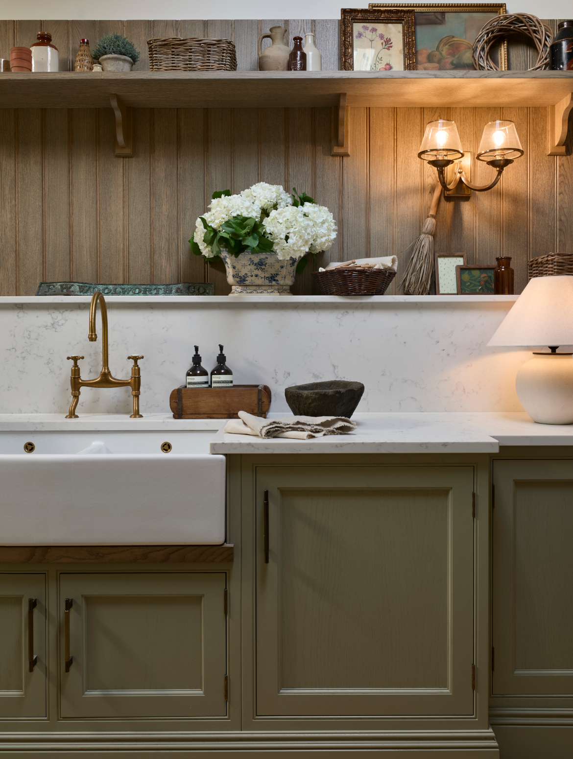 A traditional bootroom-cum-larder. The Belfast sink and worktop sits beneath two mounted cupboards. A antique brass Perin & Rowe Tap features. 