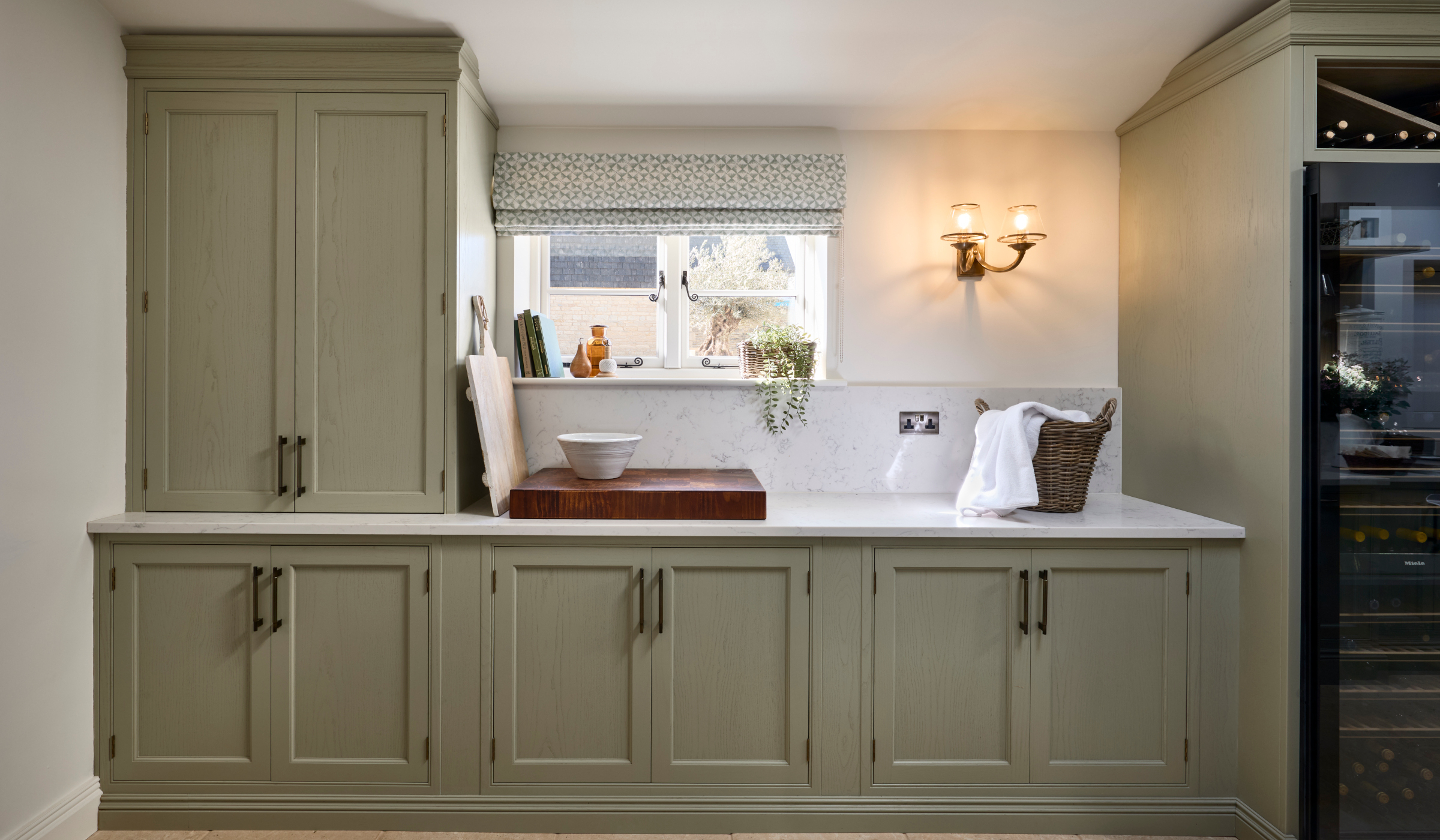 Carl-ward8-aspect-ratio-2400-1400 A traditional bootroom-cum-larder. The Belfast sink and worktop sits beneath two mounted cupboards. A antique brass Perin & Rowe Tap features.