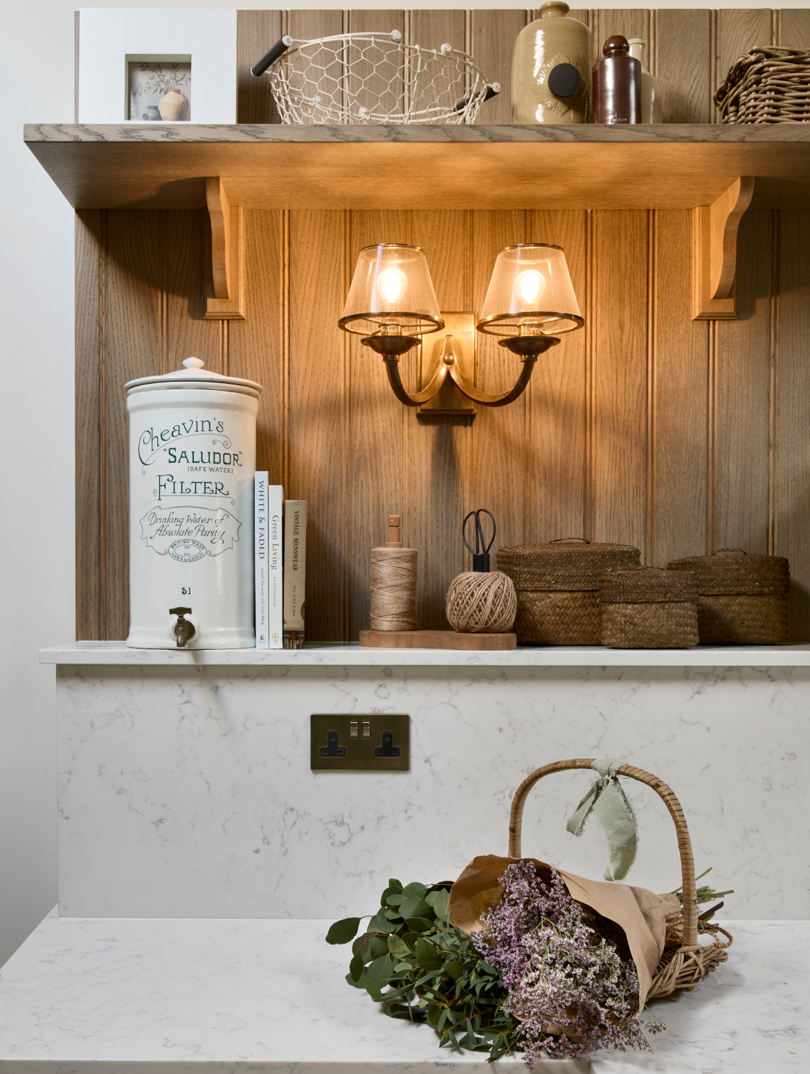 A traditional bootroom-cum-larder. The Belfast sink and worktop sits beneath two mounted cupboards. A antique brass Perin & Rowe Tap features. 
