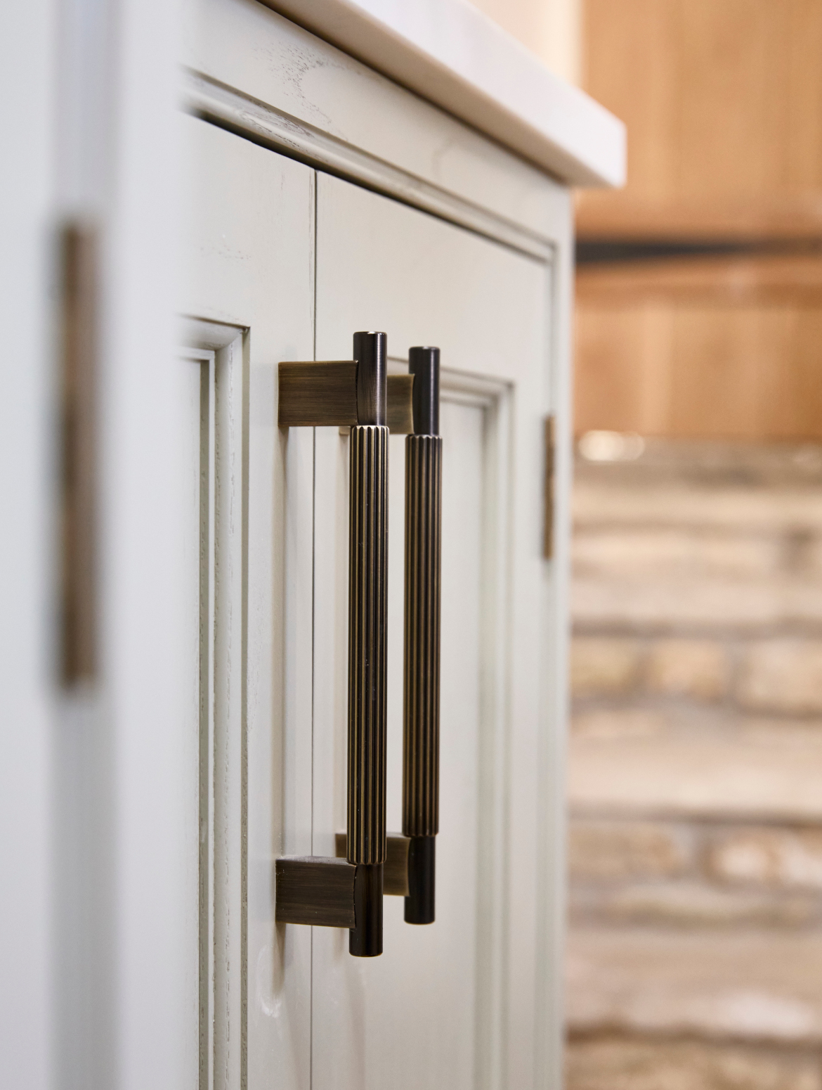 A traditional bootroom-cum-larder. The Belfast sink and worktop sits beneath two mounted cupboards. A antique brass Perin & Rowe Tap features. 