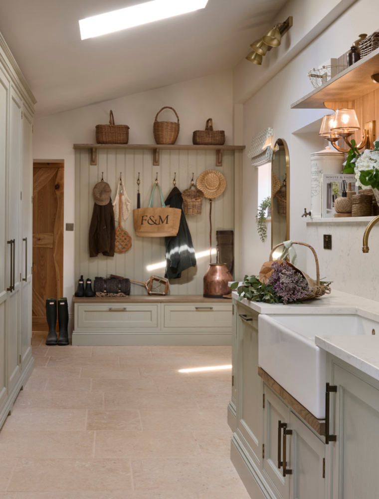 A traditional bootroom-cum-larder. The Belfast sink and worktop sits beneath two mounted cupboards. A antique brass Perin & Rowe Tap features. 